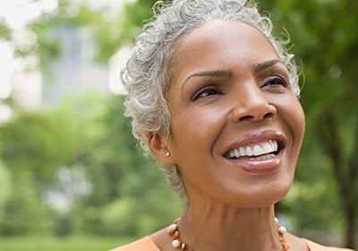 happy older woman looking up into the air