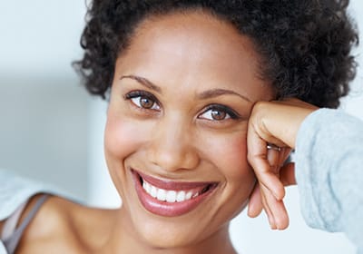 smiling woman leaning on her hand