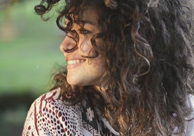 woman looking over her shoulder and smiling